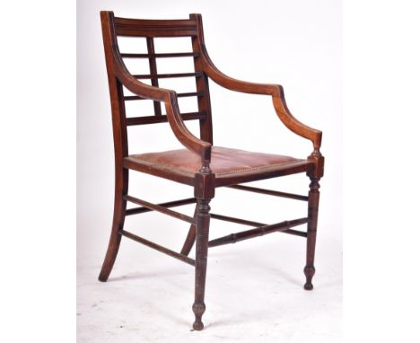 A 19th century Aesthetic movement Anglo-Japanese elbow chair / carver armchair in the manner of E.W. Godwin. The walnut chair