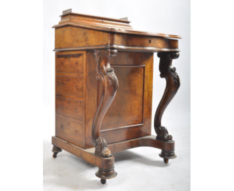 A late 19th century Victorian walnut davenport writing bureau. The desk with inkwell stand shelf mounted on sloped lidded des