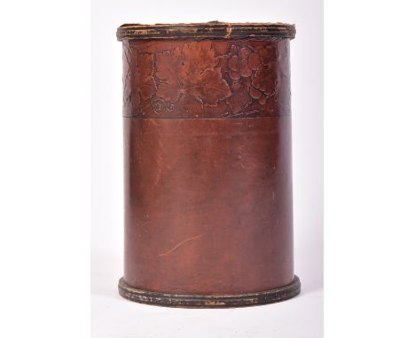 A 20th century Leatho embossed cylindrical waste bin. The leather exterior decorated with Art Nouveau flowers. Bearing label 
