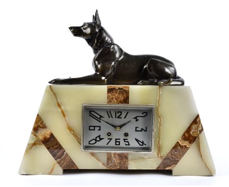 A large Art Deco marble and onyx mantel clock, surmounted with an Alsatian, 38cm high x 45cm wide x 10cm deep 