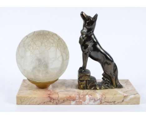 A French Art Deco onyx and spelter mantel clock, modelled as an Alsatian raised with nose to air against a frosted spherical 