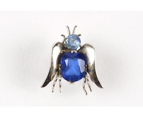 A white metal and stone set bug brooch,  modelled as a fly with blue paste abdomen and light blue paste head with a spiral wi