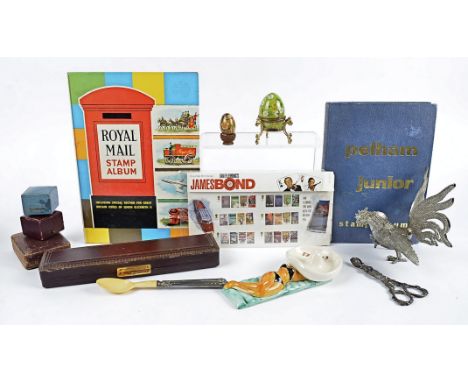 A collection of miscellaneous items, including a Bilston enamel 1973 Easter Egg and stand, a papier mache egg, a pair of silv