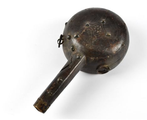 A 19th Century carved wood and metal mounted powder flask of circular form with flattened base and tapered spout,  stud mount