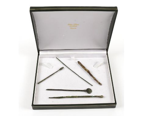 Five Egyptian period metal surgical tools,  all of pin like form, some with decorative work  