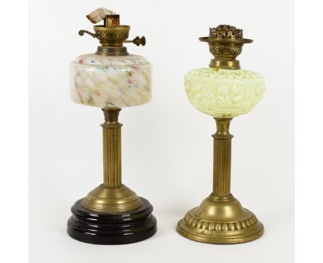 A brass oil lamp, with uranium tinted glass shade, height of base approximately 37cm, together with two other glass oil lamps