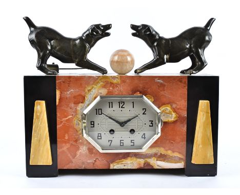 An Art Deco onyx and marble mantel clock, of rectangular shape with octagonal silvered face, Arabic numerals, surmounted by a