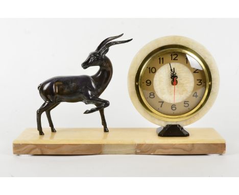 A French Art Deco mantel clock, in cream and brown marble, circular brass face with Arabic numerals and a modern electric mov