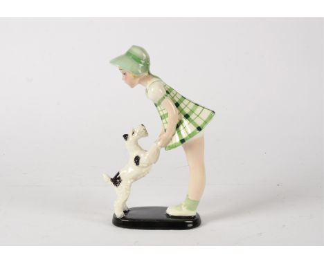 A Goldscheider Art Deco figure of a young girl playing with dog,  raised on a black oval base, printed factory marks and impr