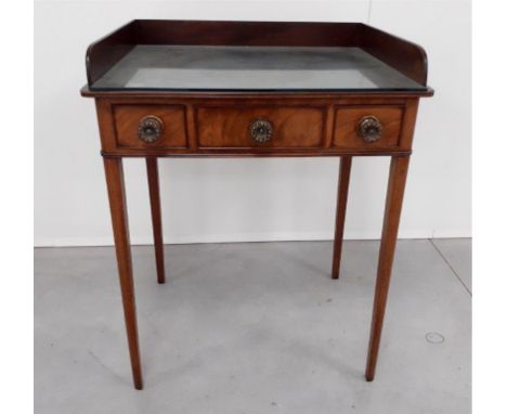 A Georgian mahogany wash stand,  gallery back, one central false drawer flanked by two short drawers, cut-outs to the top for