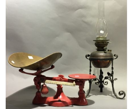 A vintage set of weighing scales and weights, together with an oil lamp