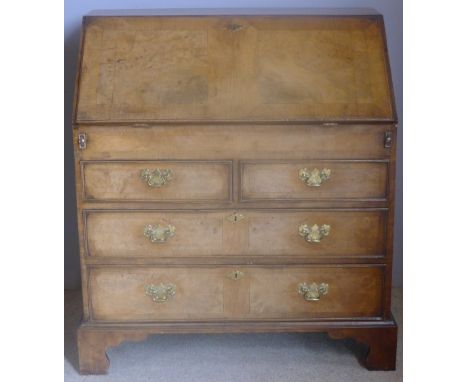 An 18th century elm and walnut bureauThe sectioned walnut fall enclosing a fitted interior above a well, over an arrangement 