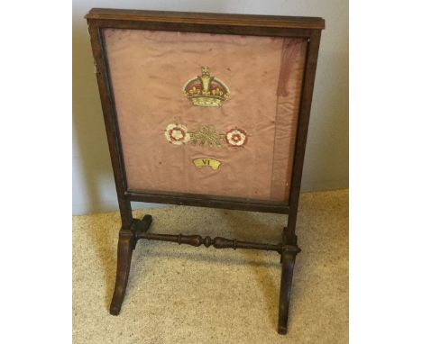 A Victorian rosewood framed firescreen, inset with a regimental crest of Irish Guards?