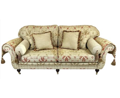 SOFA, traditional style, three seater with ottoman design fabric, raised on six turned legs and brass castors, 220cm W. 