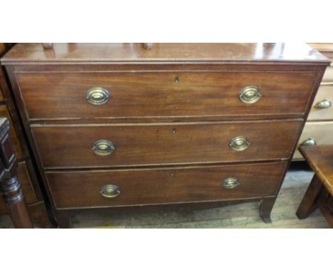 A Victorian chest of three long drawers on bracket feet