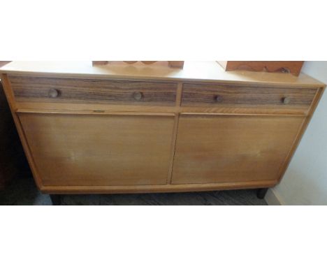 A contemporary Russell's of Broadway light Oak sideboard with darker wood drawers and drop down door cupboards below on legs