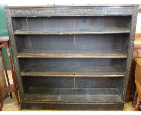 A Victorian carved Oak four shelf open bookcase