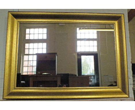 A rectangular gilt mirror and a standard lamp by Maison Design Lighting