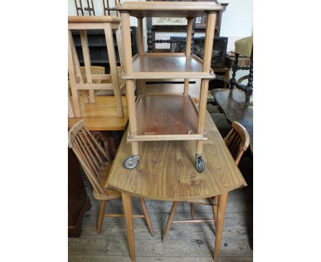 A formica top Ercol style dining table with four chairs, three dark stained chairs, a white painted chair and a tea trolley