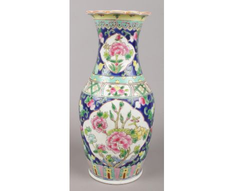 A Chinese baluster shaped vase with coloured enamel decoration depicting flowers. Seal mark to base. Height: 25.5cm  