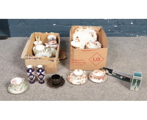 Two boxes of miscellaneous. To include cups, saucers, plates, a silver plated bell and three oriental ceramic figures etc.  