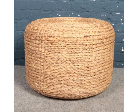A large wicker pouffe. height 47cm diameter 58cm.  