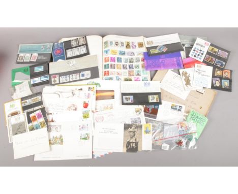 A box of first day covers and stamps. Includes First Man on The Moon, Cutty Sark, mint stamps, book of world stamps etc.  