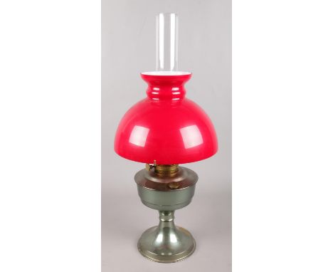 An Aladdin No. 23 oil lamp with red glass shade.  