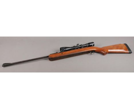 A BSA Airsporter .22 cal under-lever air rifle, fitted with a Bushmaster scope (4x40) and rubber heel. CAN'T POST THIS ITEM. 