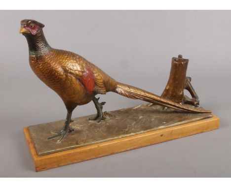 A mid 20th century cold painted spelter table lighter formed as a pheasant.  Damage to end of tail.