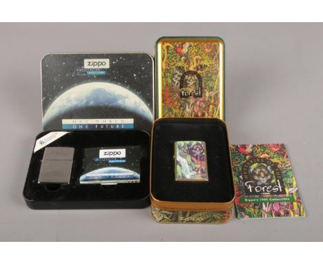 Two Zippo lighters in presentation tins. To include a Titanium coated Millennium Edition lighter along with Mysteries of the 