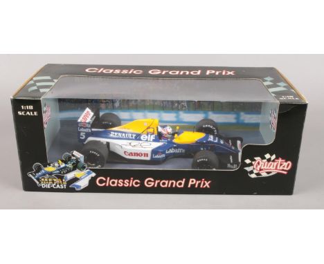 A 1:18 scale model of the 1992 Williams F1 car in original box. Bears signature Nigel Mansell on the right wing of the model.