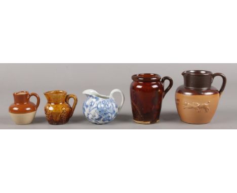 An assembly of five stone and ceramic miniature jugs. To include examples by J. Stiff &amp; Sons and Applin and Barrett.  