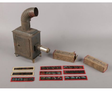 A candle powered magic lantern with two boxes of 'Primus' coloured slides.  