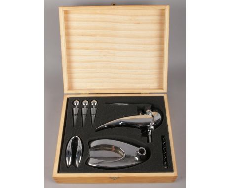 A cased wine opener set. To include bottle opener, stoppers and corkscrew.  