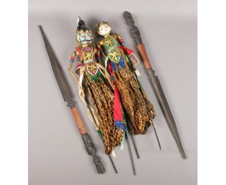 Two Indonesian stick puppets along with a pair of African tribal spears.  