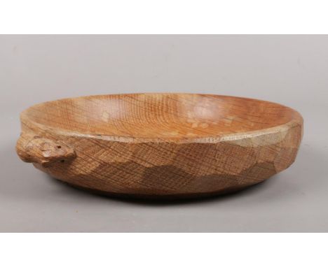 A Robert 'Mouseman' Thompson oak nut dish. with carved mouse, 15 cm diameter.  water marks to middle of dish