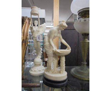 An Angel candlestick and a Grecian style figure.