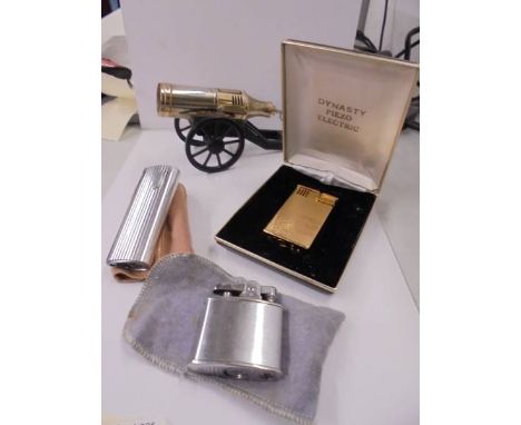 A cannon shaped cigarette lighter and three others.