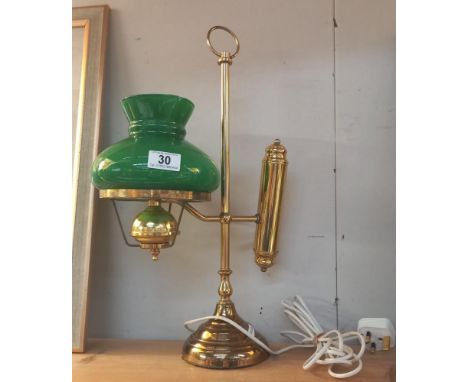 A brass student lamp with green glass shade