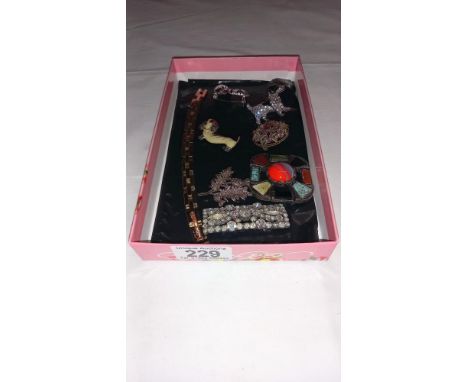 A nice lot of costume brooches and a gold plated gate style bracelet
