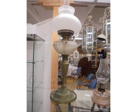 An oil oil lamp on metal base with glass font and complete with shade and chimney, COLLECT ONLY.