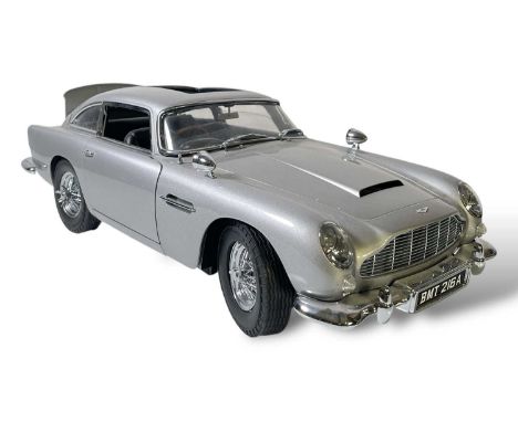 A Aston Martin DB5 scale model, built from Eaglemoss magazine issue parts. Missing left door handle, sun roof. With accompany