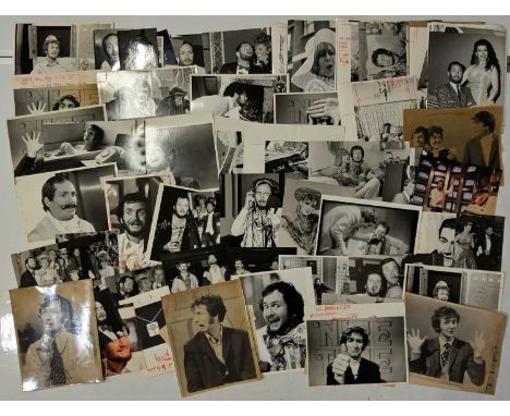 Approx 90 variously sized (most c 8x10") black and white press photographs depicting Kenny Everett, many vintage prints with 