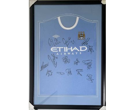 A mounted, framed and glazed display to include a c 2010 Manchester City home shirt signed by 14 squad members to inc David S