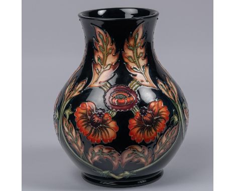 A Moorcroft pottery vase. With orange flowers on dark blue ground. Marks to base, MH, GP, gate date cypher for 1996 and M.C.C