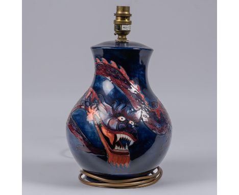 A Moorcroft pottery lamp vase. With Chinese dragon on dark blue ground. Impressed marks to base. H.310mm. VGC. £50-80 