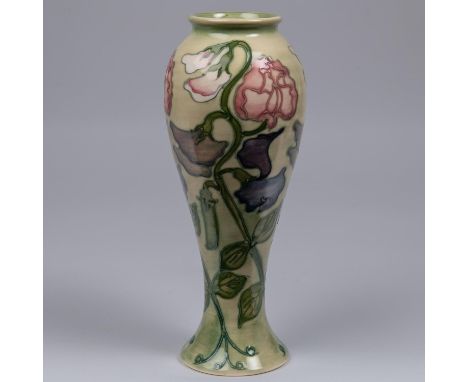 A Moorcroft pottery tall vase. With sweet peas on a light graded green base. Impressed marks to base, bell date cypher for 19