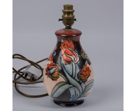 A Moorcroft pottery lamp vase. With multi-colour tulip design. Impressed marks etc to base with arrow cypher for 1991. H.255m