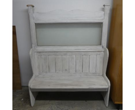 A painted pine pub bench. Overall length 127cm, height 154cm, depth 50cm, seat width 115cm, height 39cm, depth 34cm.